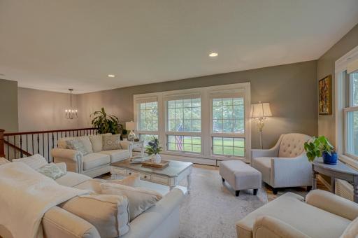 Relax in this inviting living room featuring large picture windows
