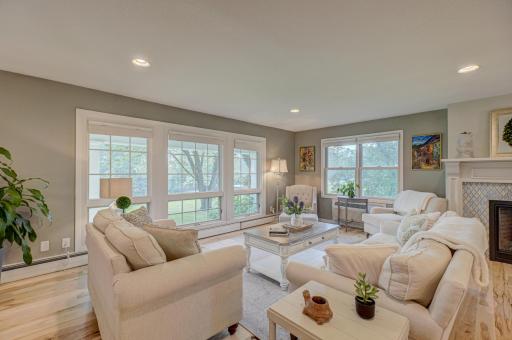 Enjoy tons of natural light in this bright and spacious living room, featuring a cozy gas fireplace that adds warmth and charm to the space
