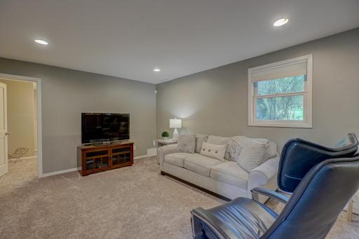 The finished lower level offers a spacious family room, two additional bedrooms, a renovated bathroom, and a dedicated laundry room