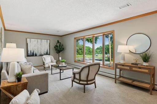 The main level living room has a large picture window that overlooks the park across the cul-de-sac and you can even see Lake Waconia!