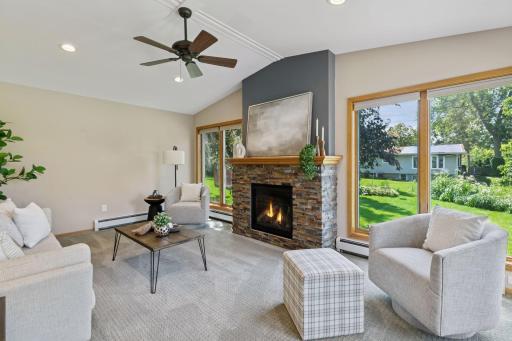 The main level family room is bright and airy, with vaulted ceilings and large windows overlooking the backyard!