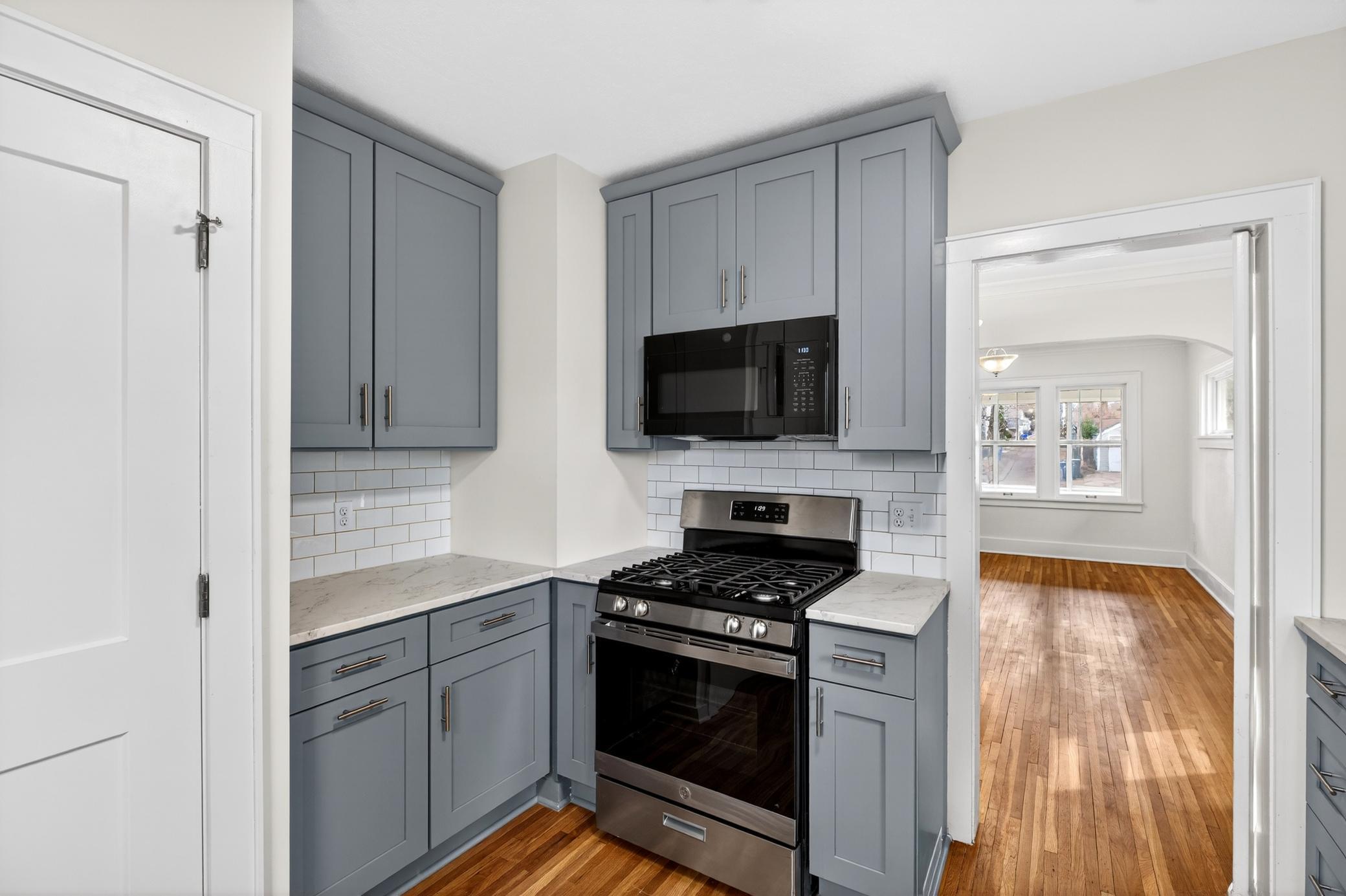The kitchen blends all the modern updates with everyday convenience - plus a charming swing door connecting to the dining room. A perfect complement to this 1920's gem.