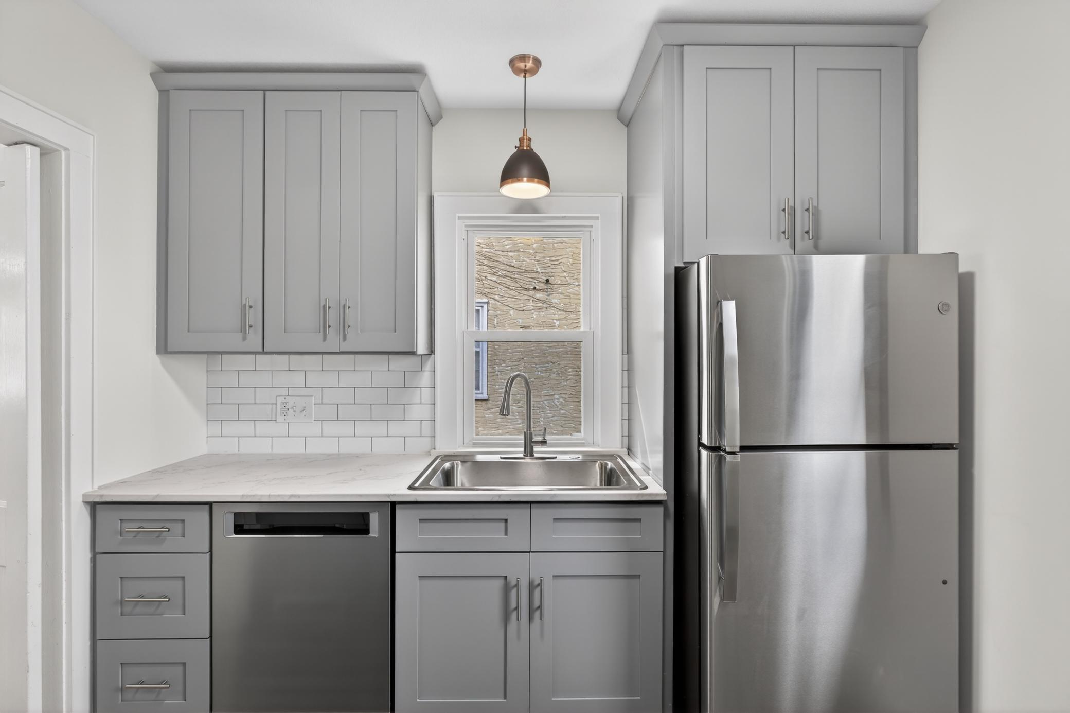 This super cute kitchen has been completely rebuilt from the studs, featuring all-new cabinetry, appliances, tile backsplash, countertops, lighting, plumbing and electrical. Filled with natural light and offering easy access to the back yard.