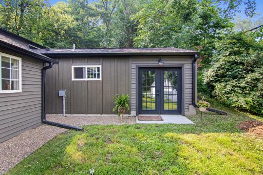 Large side yard and back building has an addition with new patio and French doors