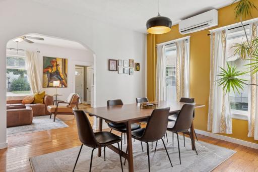 Hardwood floors flow through bright and inviting living and dining rooms
