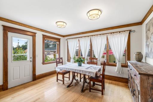 Sun-drenched dining area with tons of windows and light looking out to the backyard