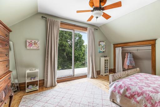 Adorable upstairs bedroom with hardwood floors, walk-in closet nook, and private access to the flat rooftop