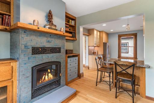 Cozy fireplace with a heat vent connects seamlessly to the updated kitchen with a granite breakfast bar