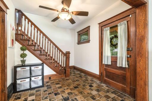 Grand entryway with rich original woodwork and tile floors