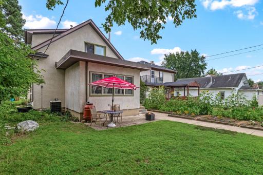 Backyard with mature trees, garden beds, and private outdoor retreat vibes