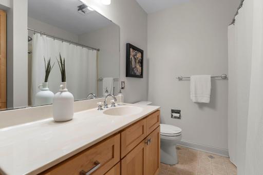 The private ensuite bath features tile flooring and a tub-shower combination.