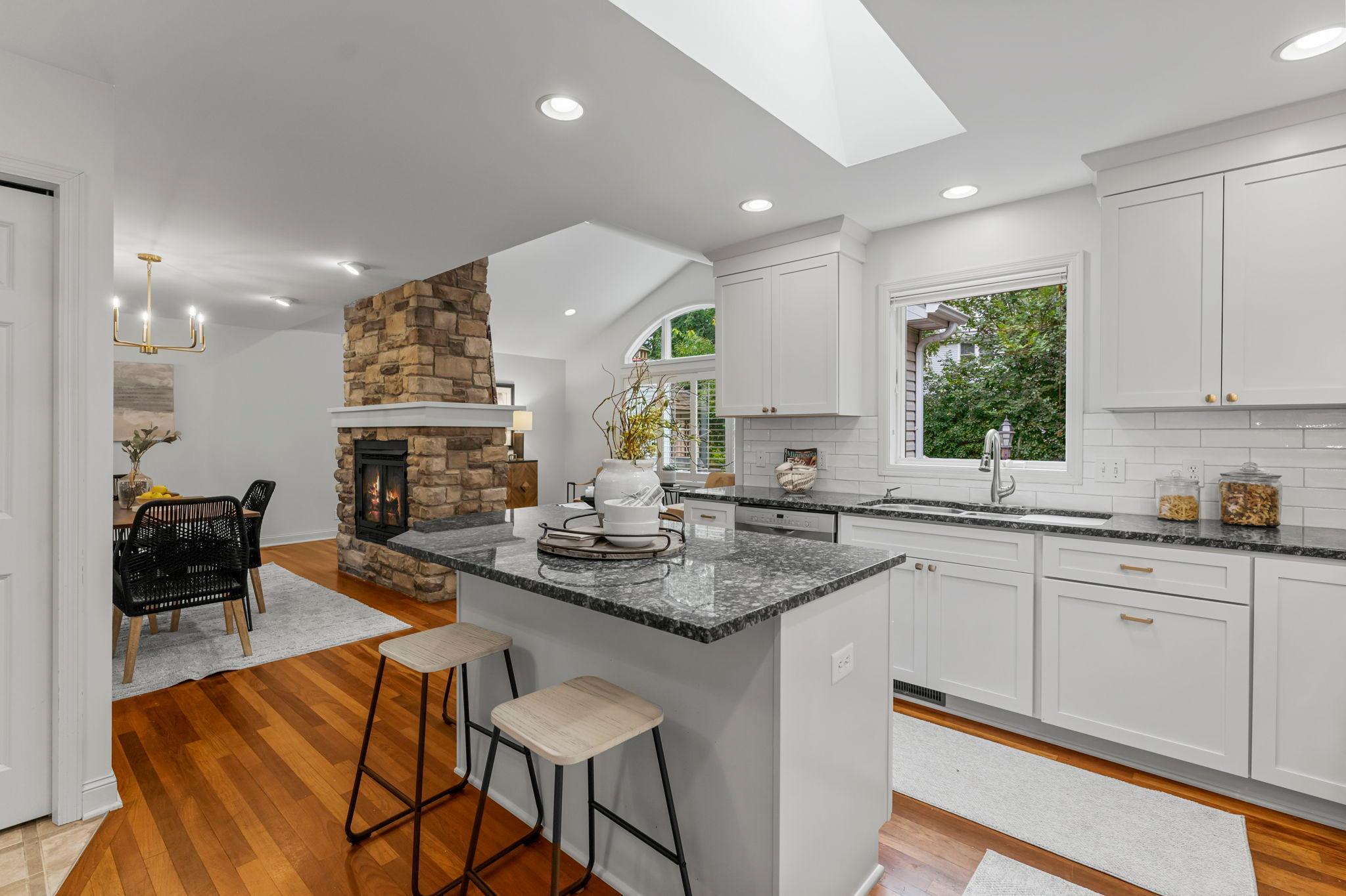 Enjoy a generous center island, stylish tile backsplash, and a skylight that brightens the space.