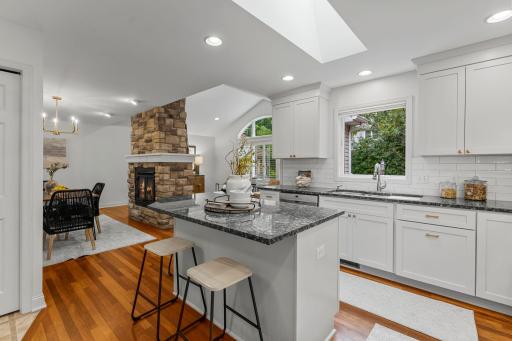 Enjoy a generous center island, stylish tile backsplash, and a skylight that brightens the space.