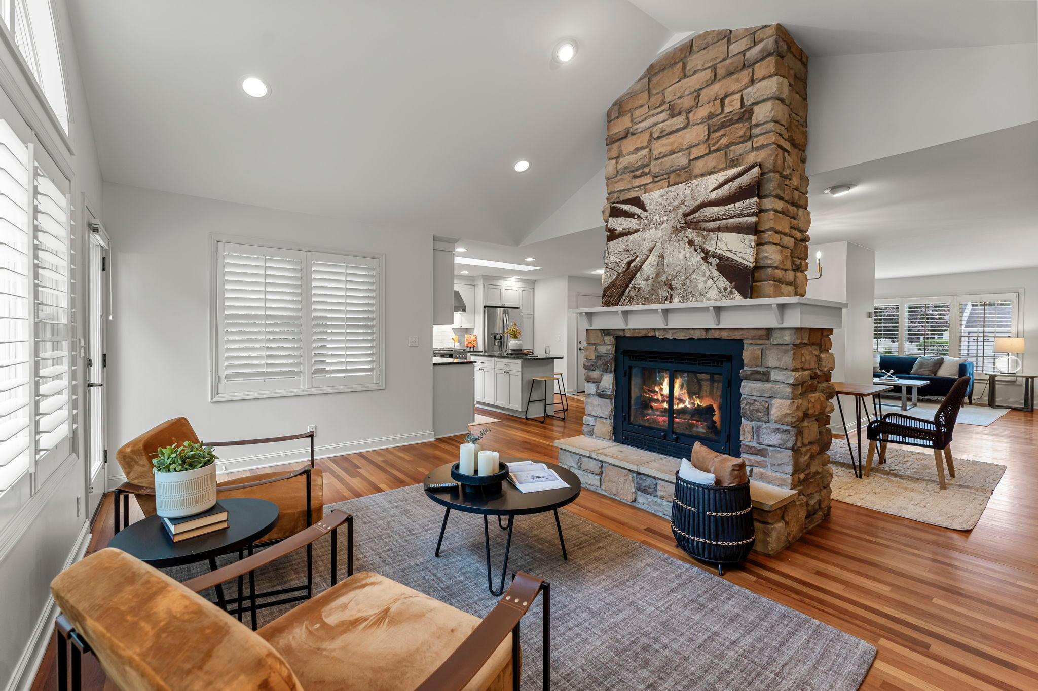 On the other side, the open family room boasts a 12-foot vaulted ceiling and walkout access to the backyard, creating an ideal space for seamless indoor-outdoor entertaining.