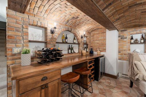 The space is complete with a wine cooler (new 2025), wine racks, and open wall shelving for character. Imagine entertaining here!