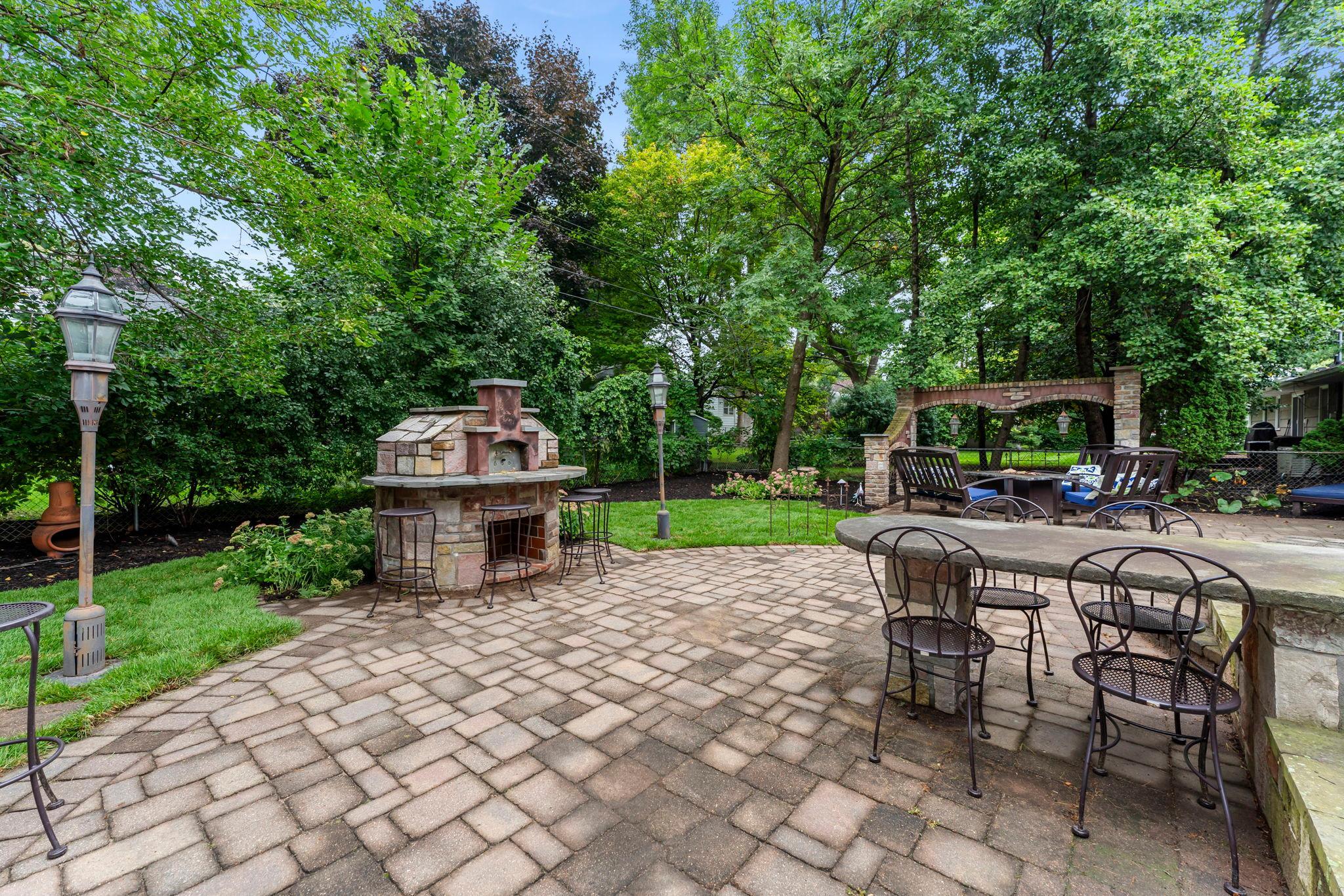 The newly refreshed landscaping—complete with outdoor lighting—enhances the fully fenced yard with both privacy and charm.