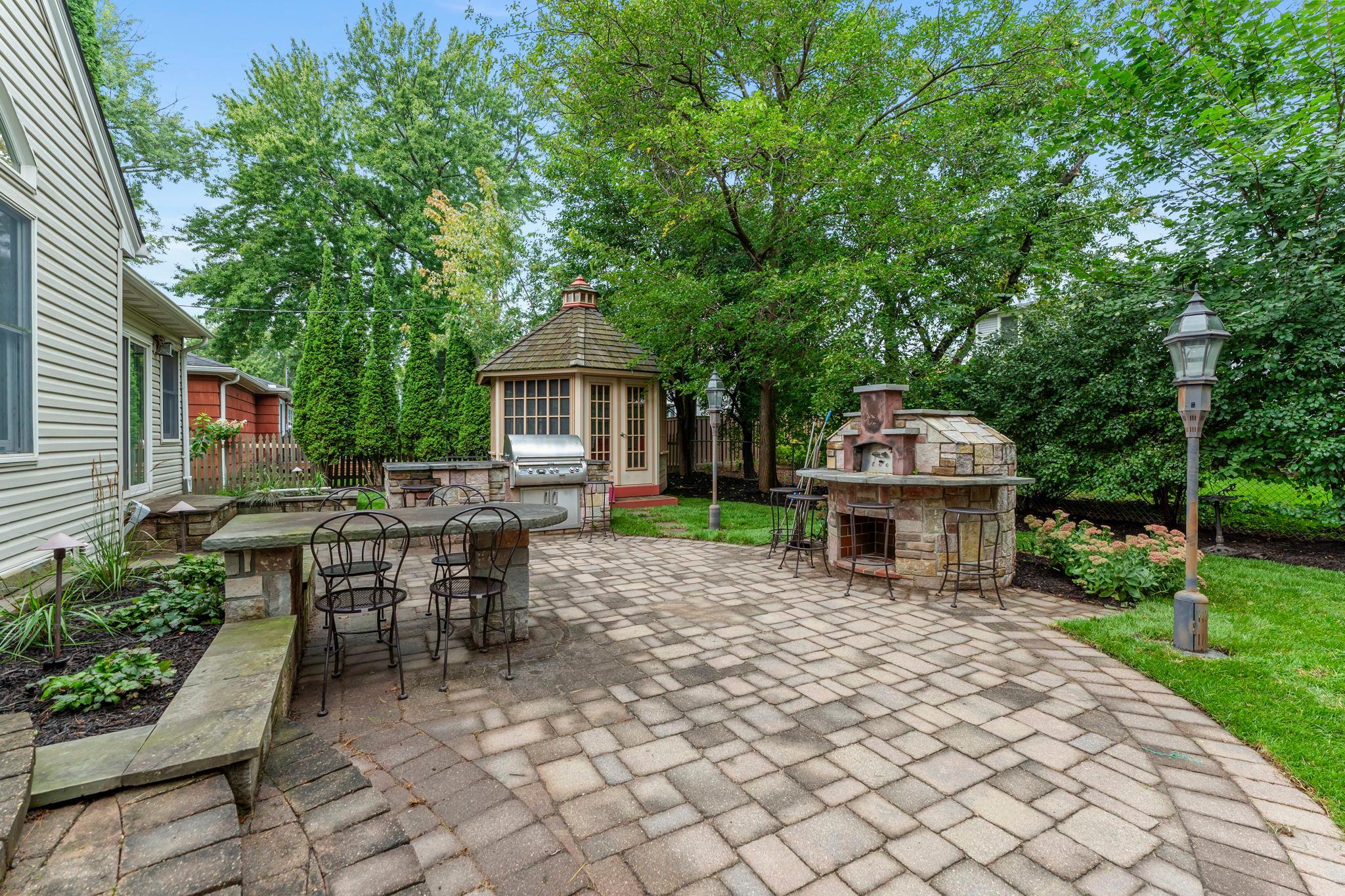 Outdoors, the home continues to impress with a large paver patio designed for unforgettable gatherings.