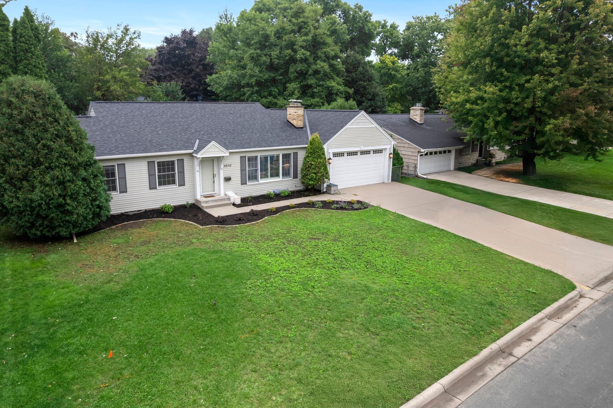 Recent updates include a new roof and kitchen skylight window, fresh landscaping, new drain tile with sump pump, new toilets, and fresh paint throughout, along with a new water heater.
