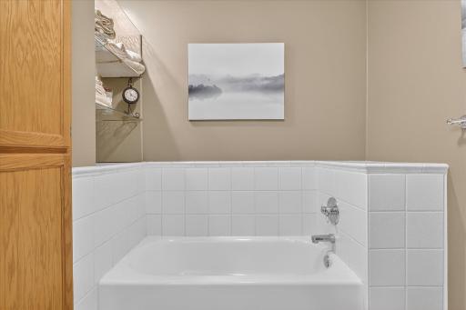 Main living level full bathroom with separate bathtub and shower.