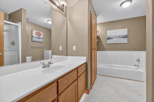Main living level full bathroom with separate bathtub and shower.