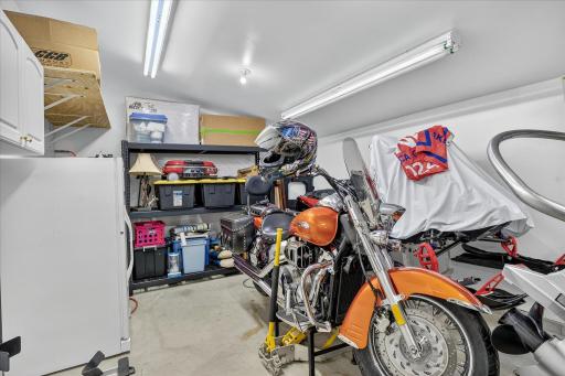 4-stall garage—fully insulated with in-floor heat, floor drain, water spigot, and ample room for vehicles, hobbies, or storage. 3rd stall is tandem.