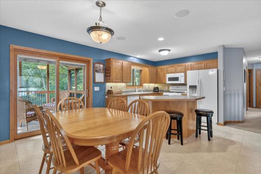 Open kitchen flows effortlessly into the dining area and screened 3-season porch—perfect for everyday living or hosting.