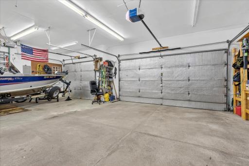 4-stall garage—fully insulated with in-floor heat, floor drain, water spigot, and ample room for vehicles, hobbies, or storage. 3rd stall is tandem.