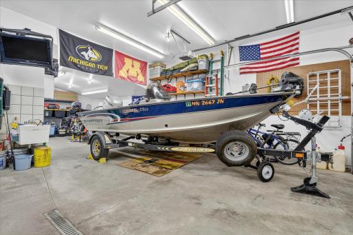 4-stall garage—fully insulated with in-floor heat, floor drain, water spigot, and ample room for vehicles, hobbies, or storage. 3rd stall is tandem.