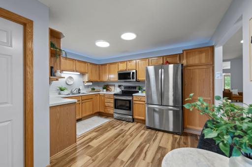 The stainless steel appliances shine in the kitchen! To the right is a good size pantry.