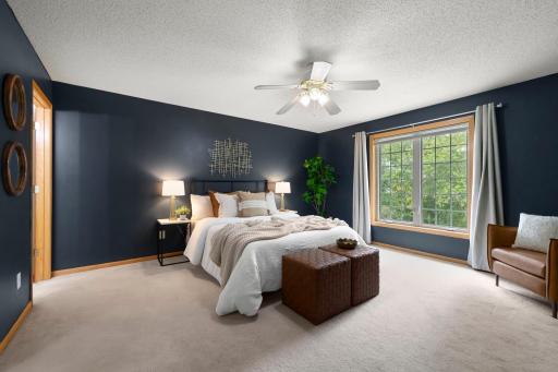 The primary bedroom is a generous size and looks out to the private backyard.