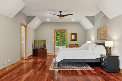 Serene and spacious, the primary suite features rich hardwood floors, vaulted ceilings, and tranquil viewsâoffering a peaceful retreat at the end of the day.
