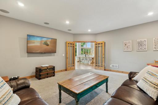 Versatile main-level den with French doors and built-in surround soundâperfect for a cozy TV lounge, home office, or game room just off the main living space.