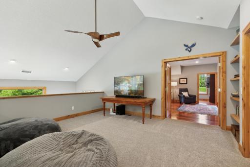 Spacious upper-level loft offers a versatile living areaâperfect for a media space, reading lounge, or play zone. Built-in shelving and open sightlines add both function and charm