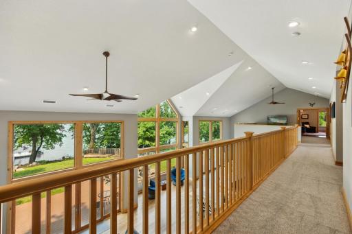 Upper-level hallway connects all bedrooms and the loft, while offering breathtaking views of the lake and great room below.