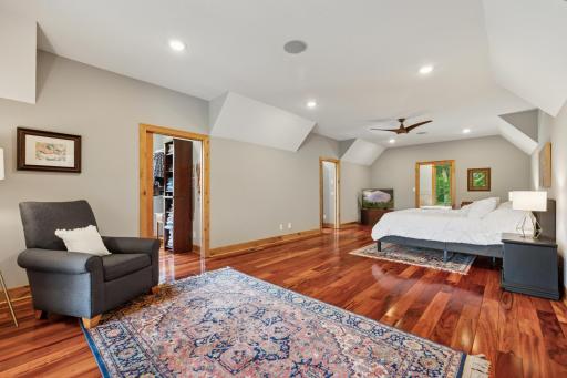 Expansive primary suite featuring rich wood floors, dual walk-in closets, and a luxurious ensuite bathâyour own private retreat with space to truly unwind.
