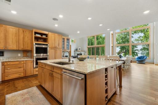 Impressive center island offers ample prep space, built-in wine storage, and an abundance of cabinetryâcombining beauty and functionality in the heart of the home.