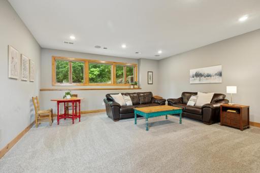 Spacious main-level den with large windows, plush carpet, and plenty of room to relax, work, or playâperfect as a second living area, or flex space.