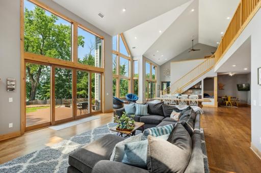 Soaring 23-foot ceilings and a full wall of west-facing windows frame breathtaking lake views in this show stopping great roomâan airy, sun-drenched space perfect for both entertaining and everyday living