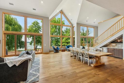 Beneath the vaulted peak, a cozy window-side nook invites quiet moments, framed by floor-to-ceiling views and warm natural light.
