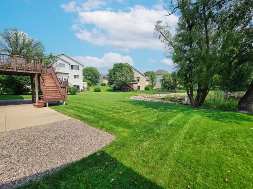 Manicured Back yard oasis with large concrete patio over looking a peaceful private Pond