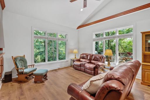 Large windows in the living room flood the room with natural light. The mature trees will make you feel like you are in a treehouse.