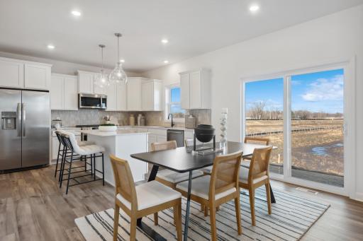 (Photos of model home, finishes will vary) The dining room is situated among the open floorplan, making it easy to move between the kitchen and Great Room.