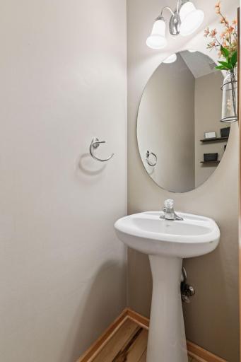 Main level 1/2 guest bath discreetly located off the kitchen.