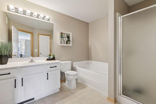 Upper level full bath with a separate jetted bath and shower.