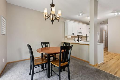 Spacious semi-formal dining area with an elegant chandelier.
