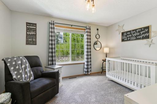 Upper level second bedroom, generous in size with a side facing window.