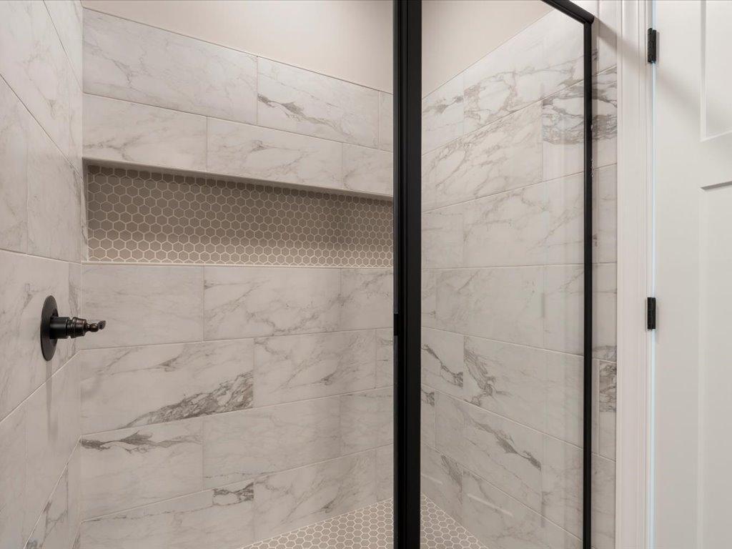 Tile shower with large niche looks amazing.