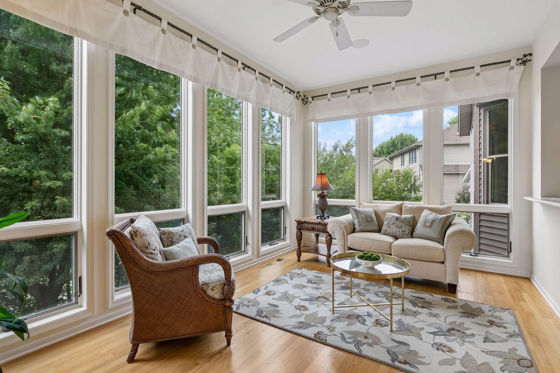 Sun filled sunroom with floor to ceiling windows