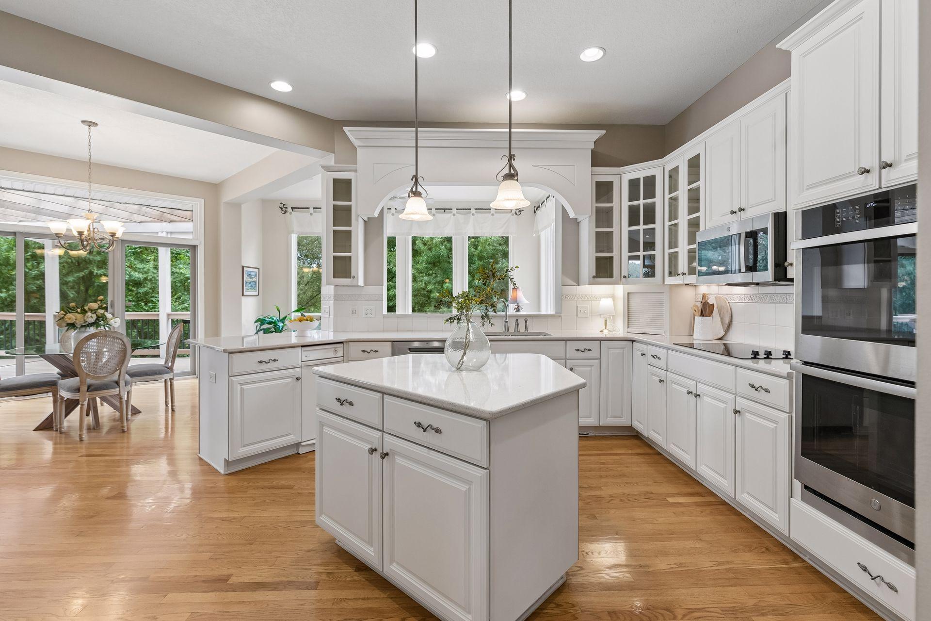 Kitchen features stainless steel double ovens, cooktop, microwave, fridge and dishwasher