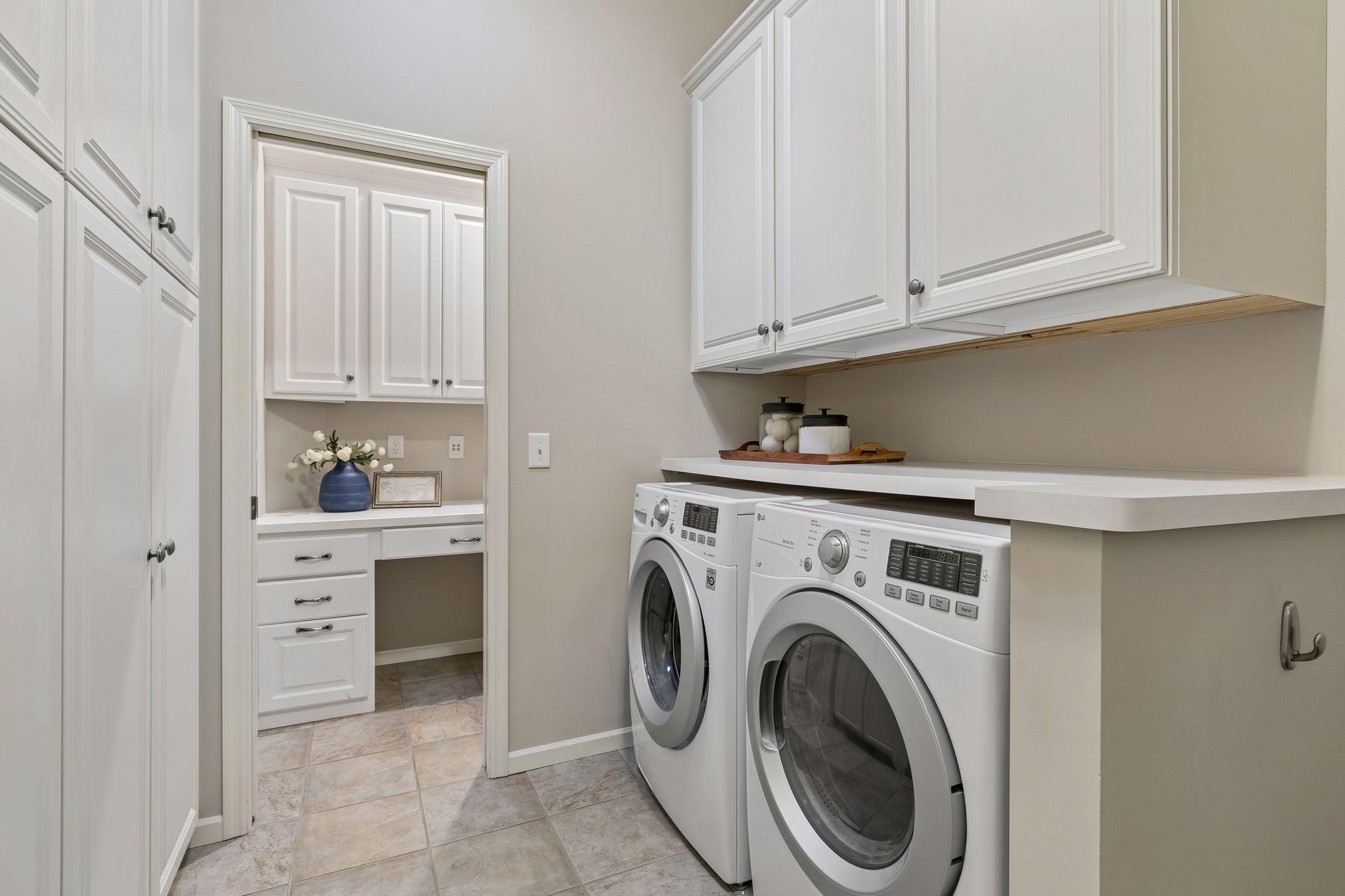 Large mudroom/laundry room with built-ins and a separate office nook room